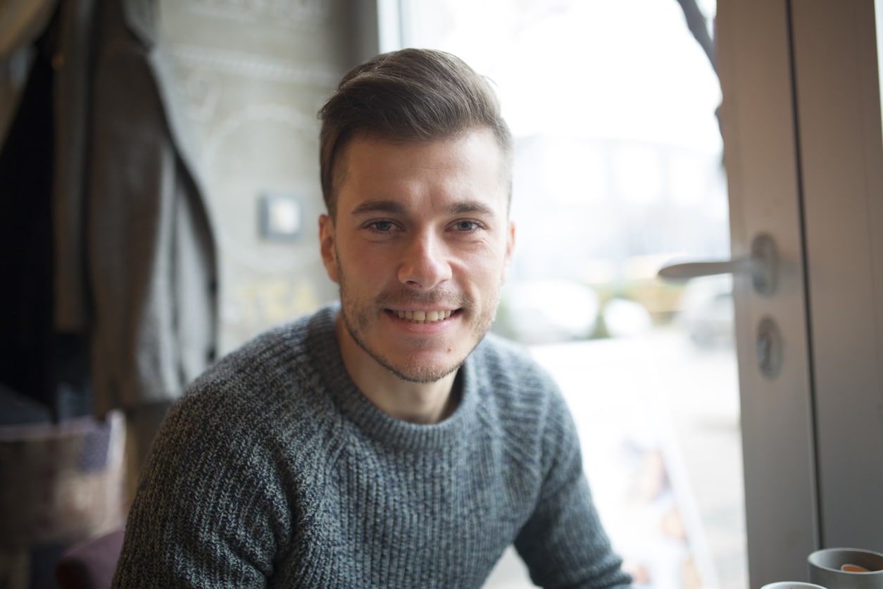 Young Man Sitting in a Restaurant