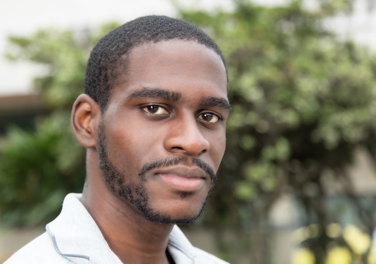 Smiling african man with beard outdoor in the city